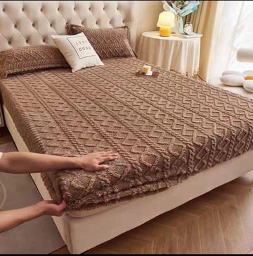 Soft chenille fitted bed cover in brown with textured geometric pattern on a beige upholstered bed