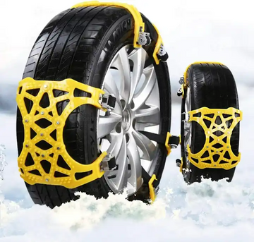 ForKumi universal snow chains for tires in yellow installed on car tires on snowy ground