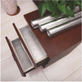 ForKumi aluminum foil kitchen sticker rolls displayed on a wooden table with one applied inside a drawer for protection