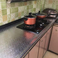 ForKumi aluminum foil kitchen sticker applied on kitchen countertop behind stove with cookware