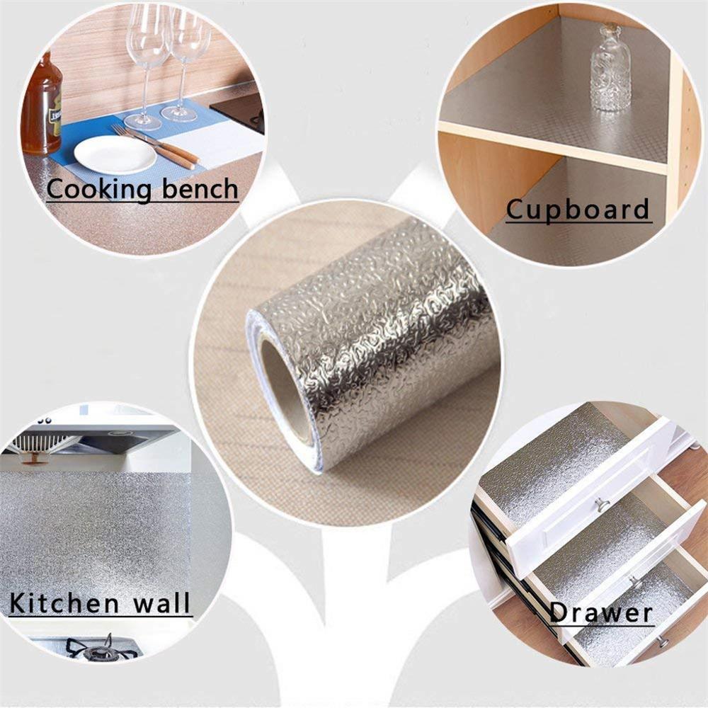 ForKumi aluminum foil kitchen sticker roll with application examples on cooking bench, cupboard, kitchen wall, and drawer