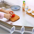 ForKumi aluminum foil kitchen sticker covering countertop with person slicing tomato on wooden board