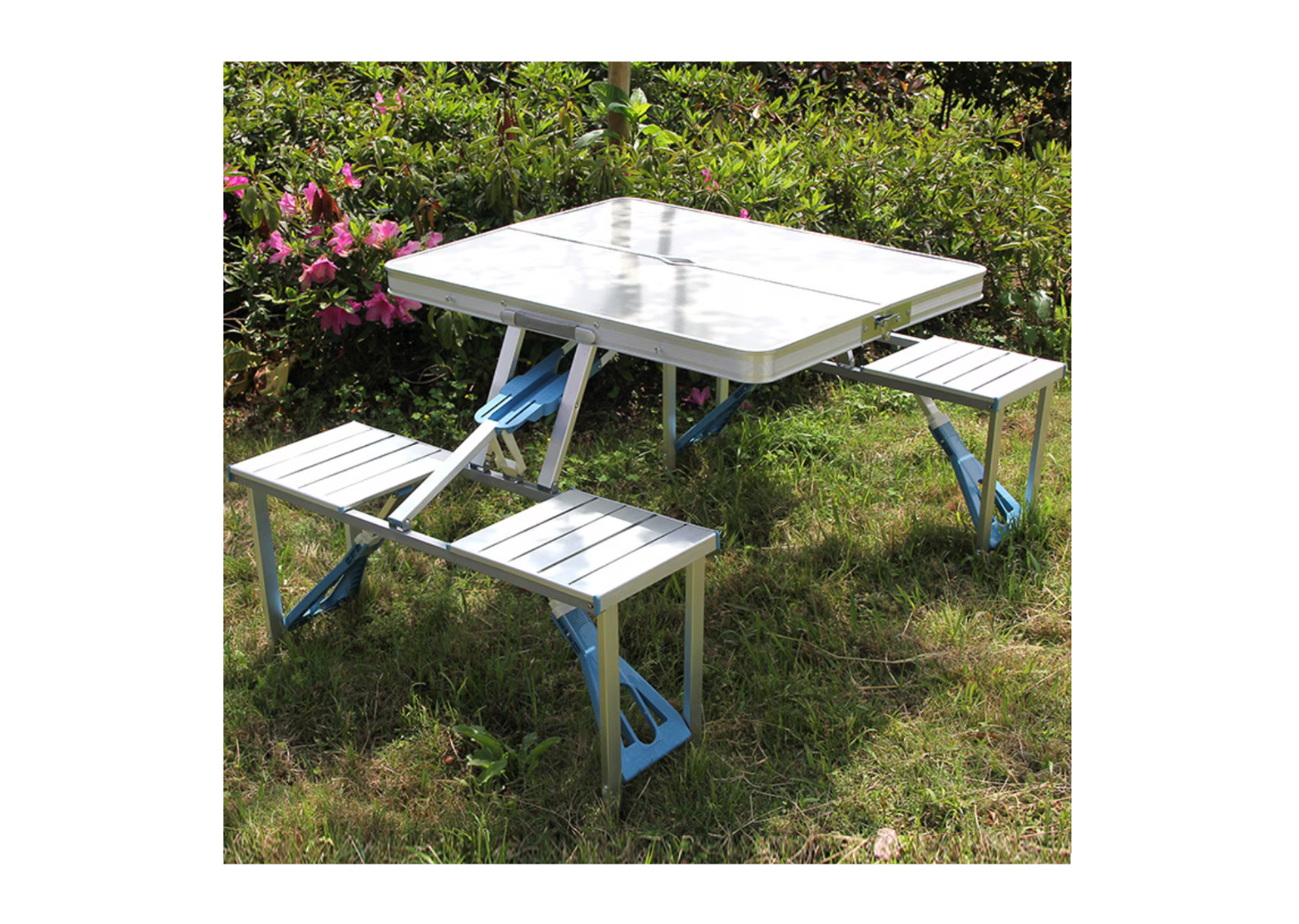 ForKumi folding patio table set with white tabletop and attached benches on green grass