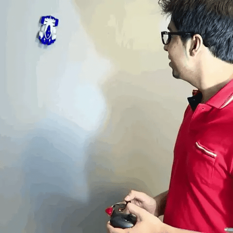 ForKumi anti-gravity remote control car in blue silver with controller climbing wall and kid playing