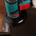 ForKumi 48V cordless angle grinder in use cutting metal with blue and red handle design