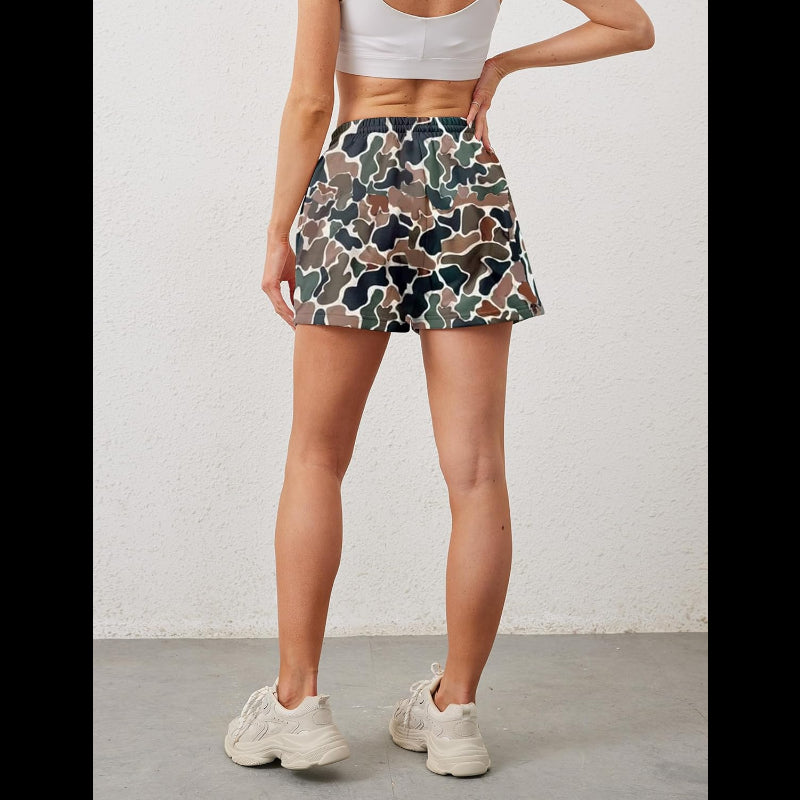 Avis camo elastic waist shorts worn by woman from the back with white crop top and sneakers