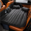 ForKumi car air mattress with pump in black inflated on backseat of car with two pillows