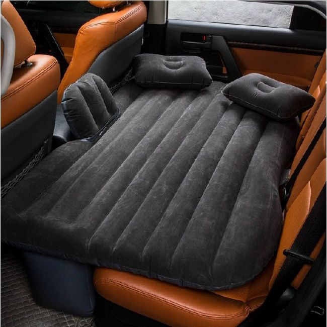 ForKumi car air mattress with pump in black inflated on backseat of car with two pillows