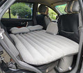 ForKumi car air mattress with pump inflated and set up in the back seat of a car with pillows