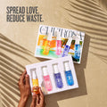 ForKumi warm gourmand perfume mist set with four colorful spray bottles held by hands on beige surface
