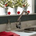 ForKumi dual temperature kitchen faucet in brushed metal finish installed on white countertop with stainless steel sink