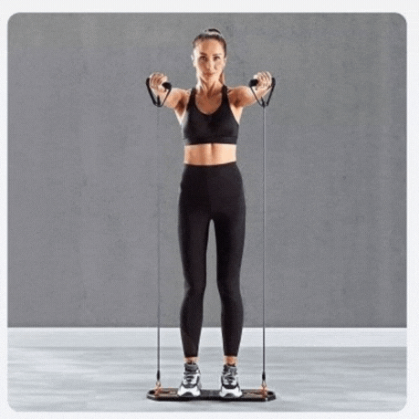Woman exercising with ForKumi foldable pushup board set using resistance bands in black workout outfit