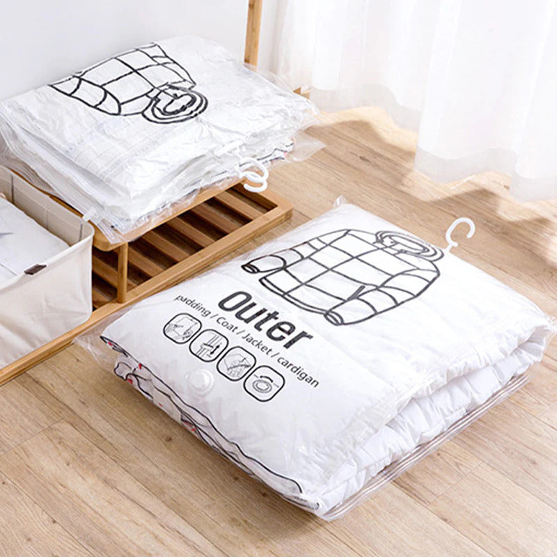 ForKumi vacuum storage bags for clothes neatly compressing jackets on a wooden floor near a shelf