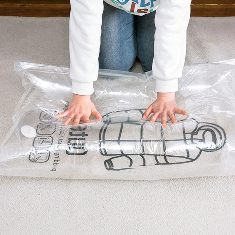ForKumi vacuum storage bags for clothes being compressed by hands on carpet floor