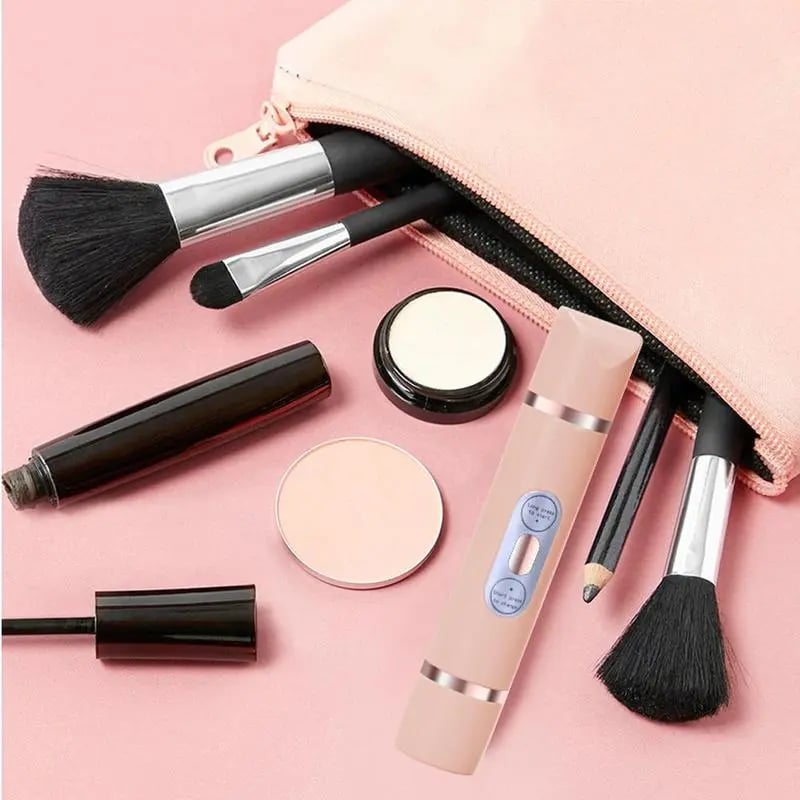 ForKumi 2-in-1 hair remover for women next to makeup brushes and cosmetic products on pink background