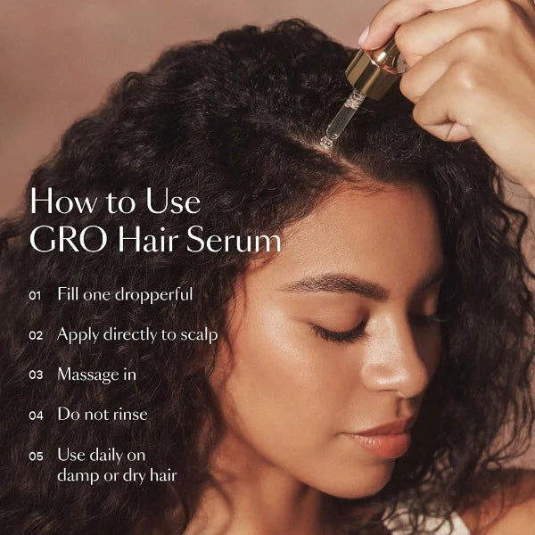Woman applying hair serum for shiny hair directly to scalp using a dropper for hair care