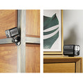 ForKumi HD WiFi security camera mounted on wooden door frame and placed on wooden table