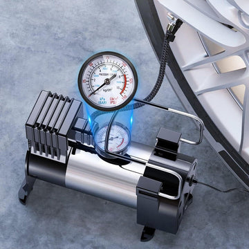 Avis high-pressure tire inflator connected to car tire with pressure gauge on gray background