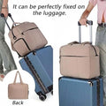 ForKumi lightweight gym duffle bag 40L in beige attached securely to blue rolling luggage