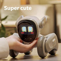 Loona AI robot pet with digital face being held by a hand on a table in a cozy room