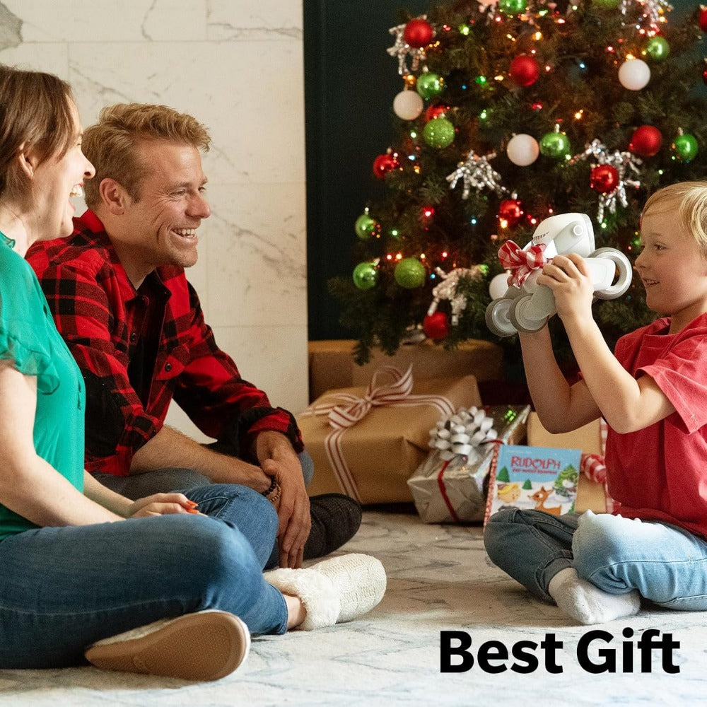 Child holding Loona AI robot pet toy near Christmas tree with parents watching happily