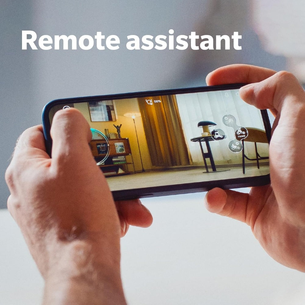 Person using a smartphone remote control to operate the Loona AI robot pet in a living room