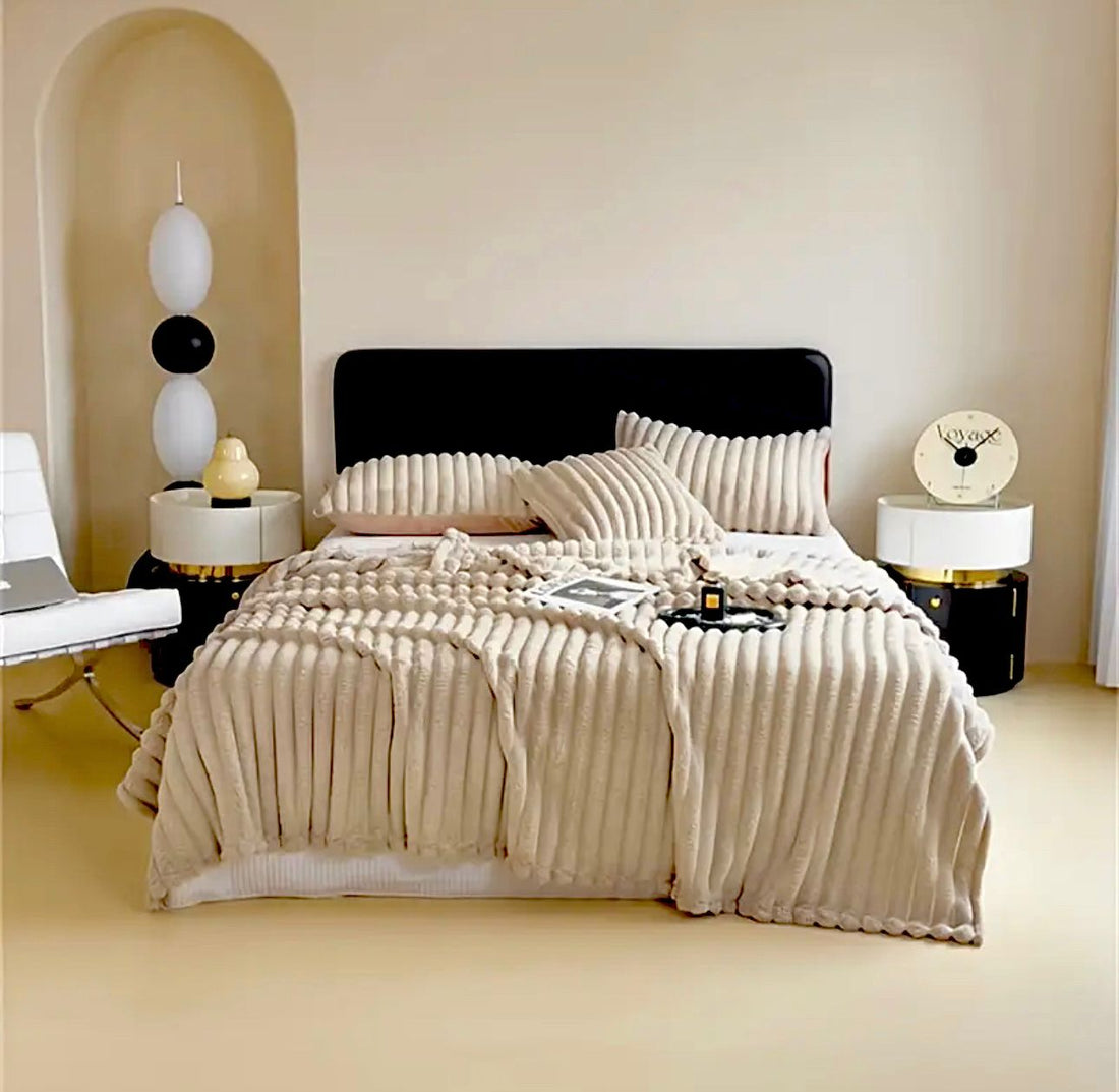Luxury reversible bed blanket in soft gray with matching pillows on modern bed by ForKumi