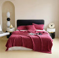 ForKumi luxury reversible bed blanket in deep red on bed with matching pillows in modern bedroom