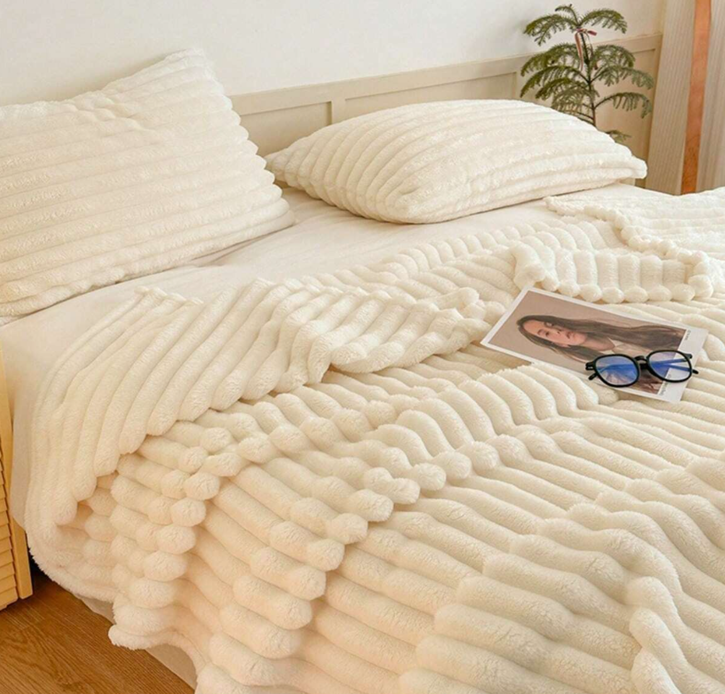 ForKumi luxury reversible bed blanket in cream color with soft textured design on bed with matching pillows