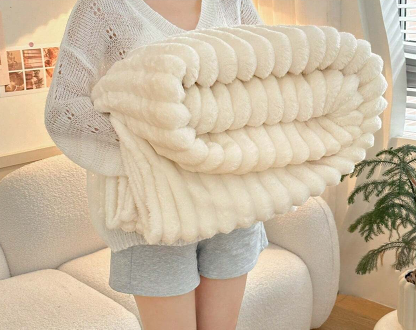 ForKumi luxury reversible bed blanket in soft cream color held by person in cozy room