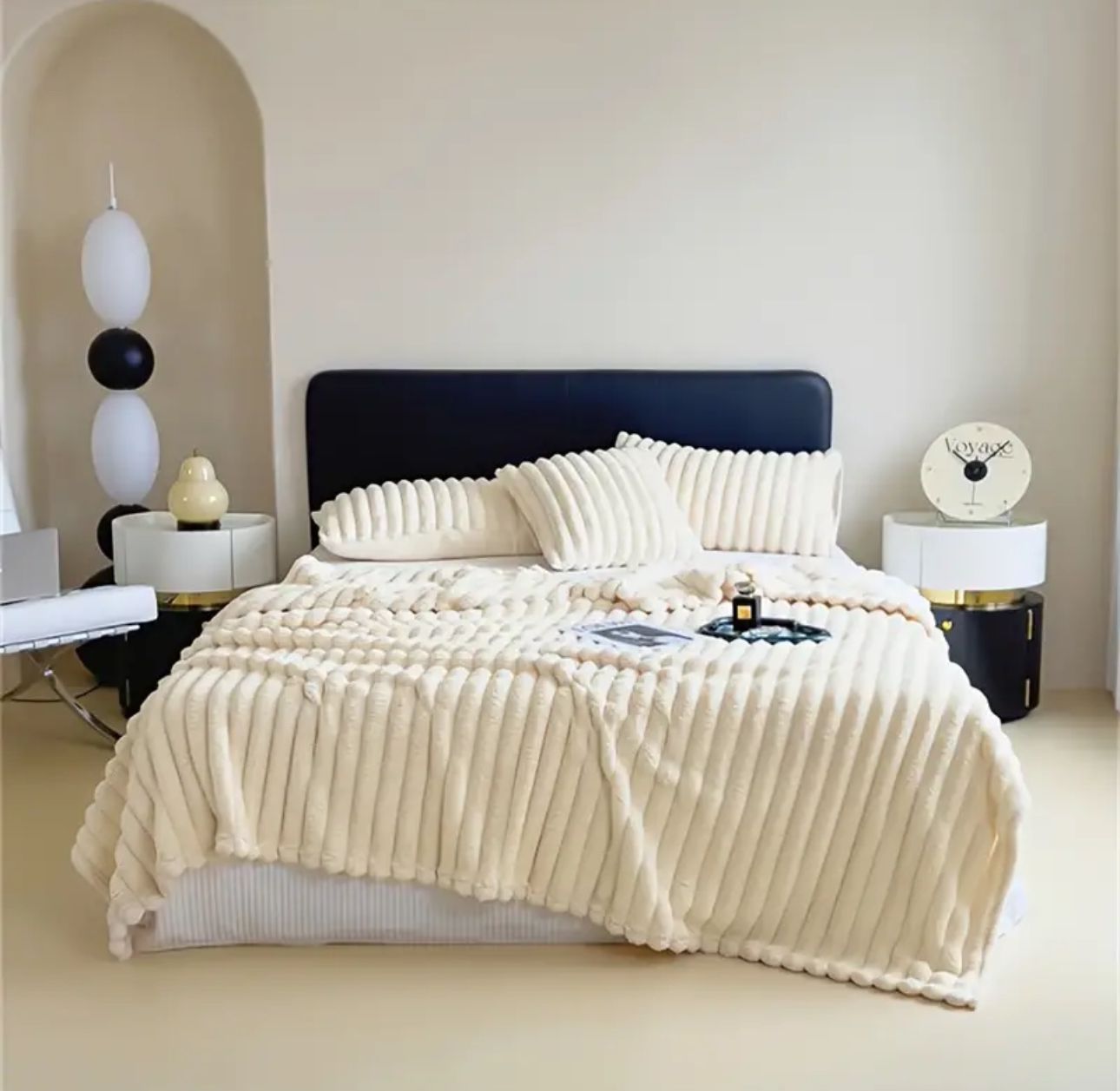 ForKumi luxury reversible bed blanket in cream color on a modern bed with matching pillows