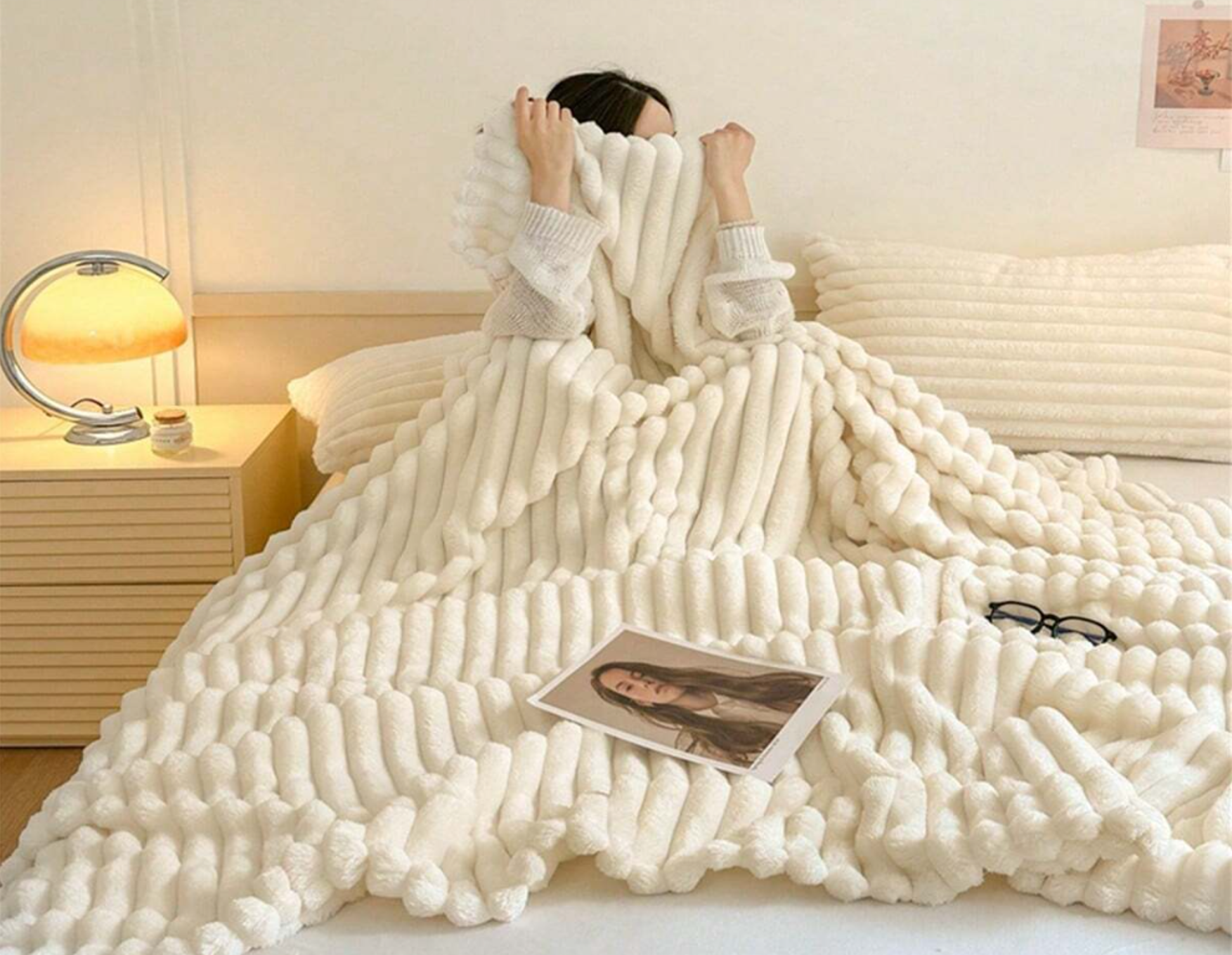 ForKumi luxury reversible bed blanket in cream color draped over bed with cozy texture