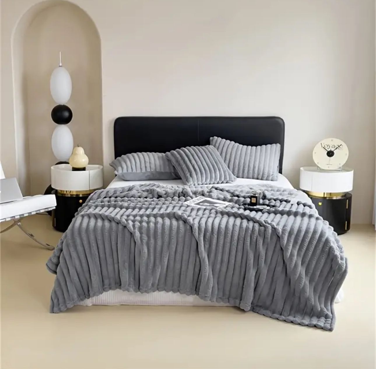 Luxury reversible bed blanket in soft gray with matching pillows on modern bed by ForKumi