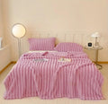 ForKumi pink luxury reversible bed blanket with matching pillows on a modern bed in a cozy room