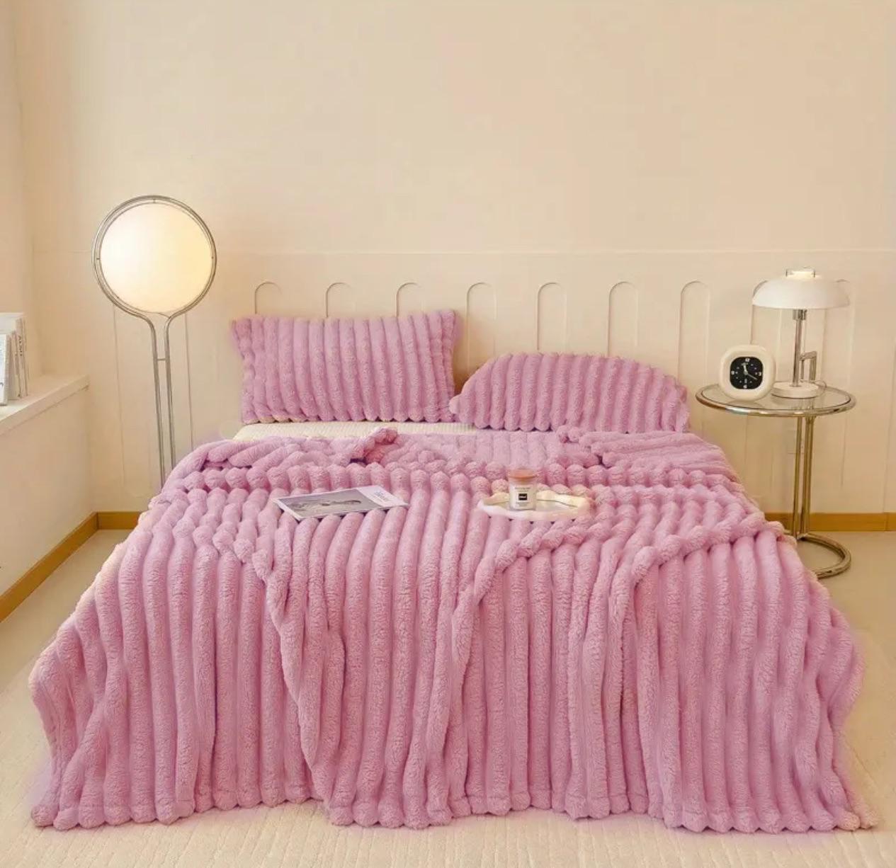 ForKumi pink luxury reversible bed blanket with matching pillows on a modern bed in a cozy room