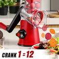 ForKumi red manual rotary grater slicing vegetables with a hand crank on a kitchen countertop