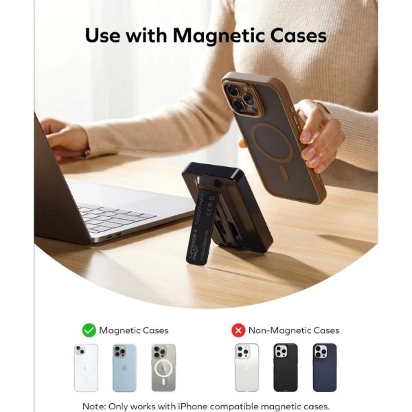 MagSafe power bank being used with a magnetic case attached to an iPhone near a laptop on a wooden desk