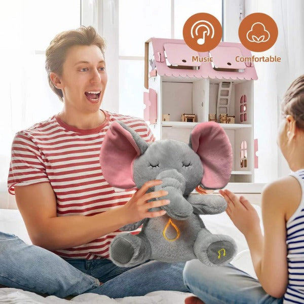 Avis musical otter soother for babies shown as a soft gray plush elephant toy with pink ears in a playful family setting