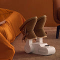 ForKumi odor eliminating shoe dryer for home with white base drying a pair of brown boots indoors