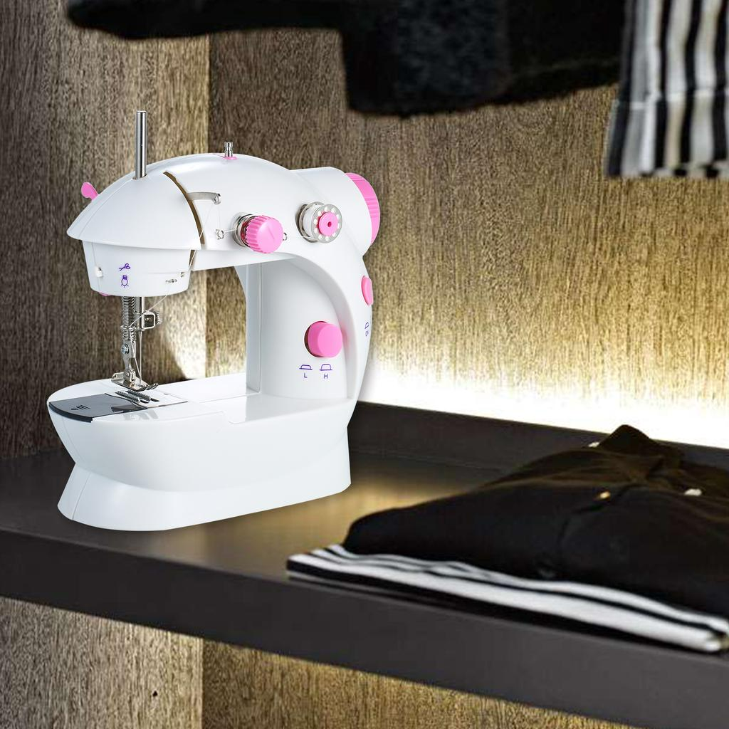 ForKumi portable 4-in-1 sewing machine in white and pink on a shelf with folded clothes