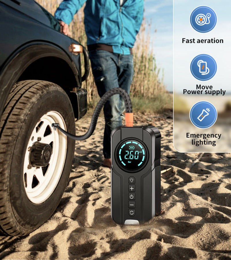 Avis portable jump starter with air compressor inflating a car tire on sandy terrain with digital display