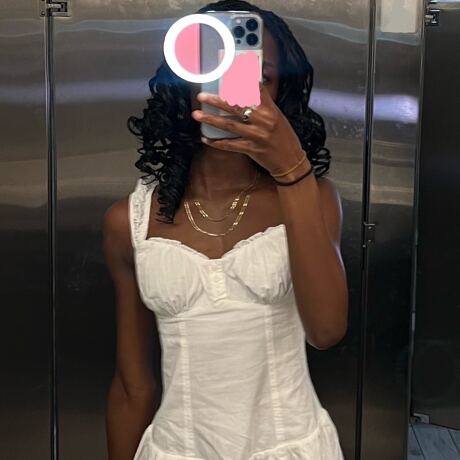 ForKumi pro selfie ring light glowing on phone held by woman in white dress taking mirror selfie