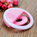 ForKumi pink pro selfie ring light with clip on wood surface and pink flowers background