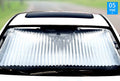 ForKumi retractable car sunshade installed on front windshield to block sunlight and reduce heat