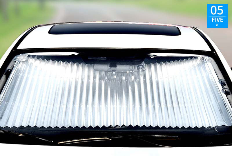 ForKumi retractable car sunshade installed on front windshield to block sunlight and reduce heat