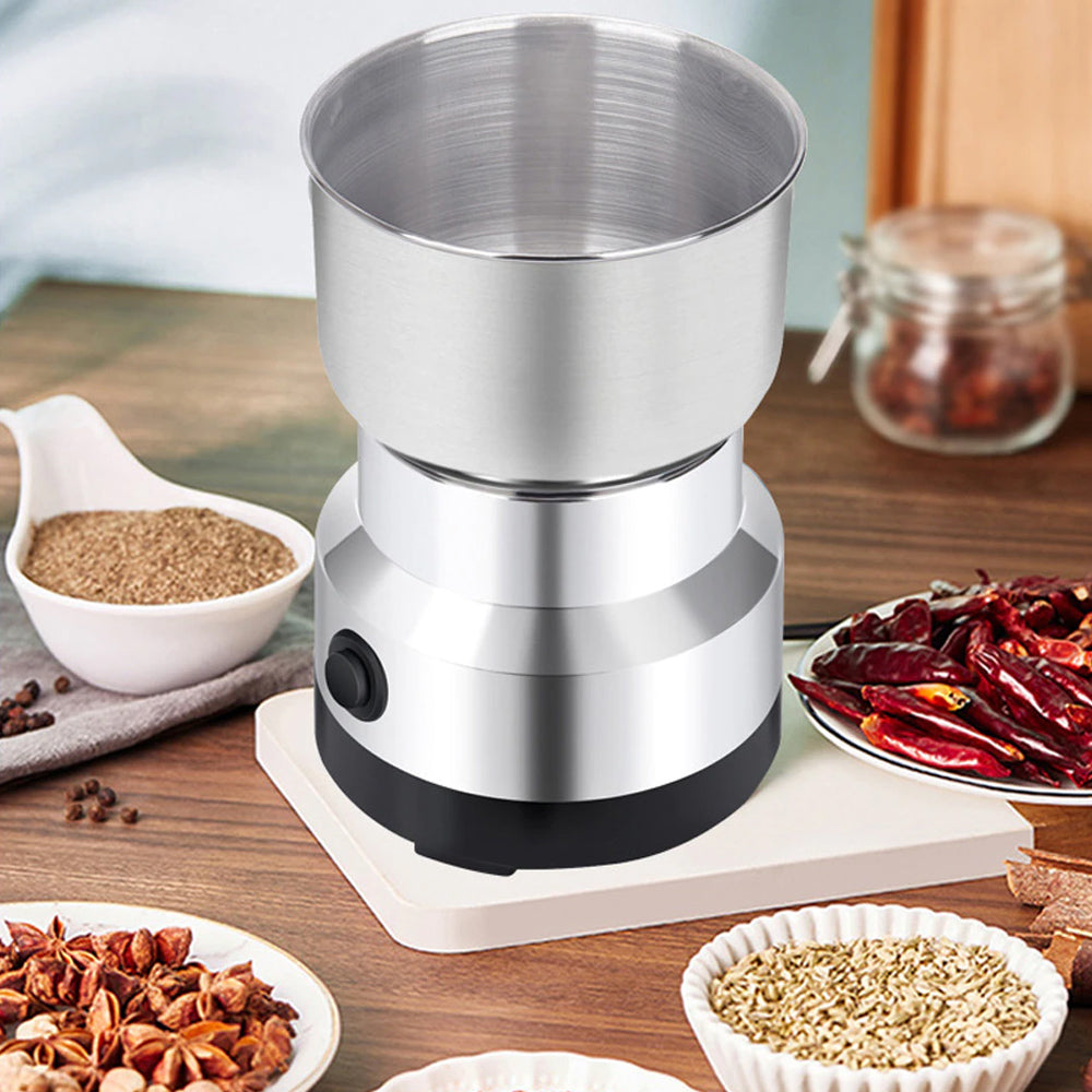 ForKumi small electric grinder for home with stainless steel bowl surrounded by spices on wooden table