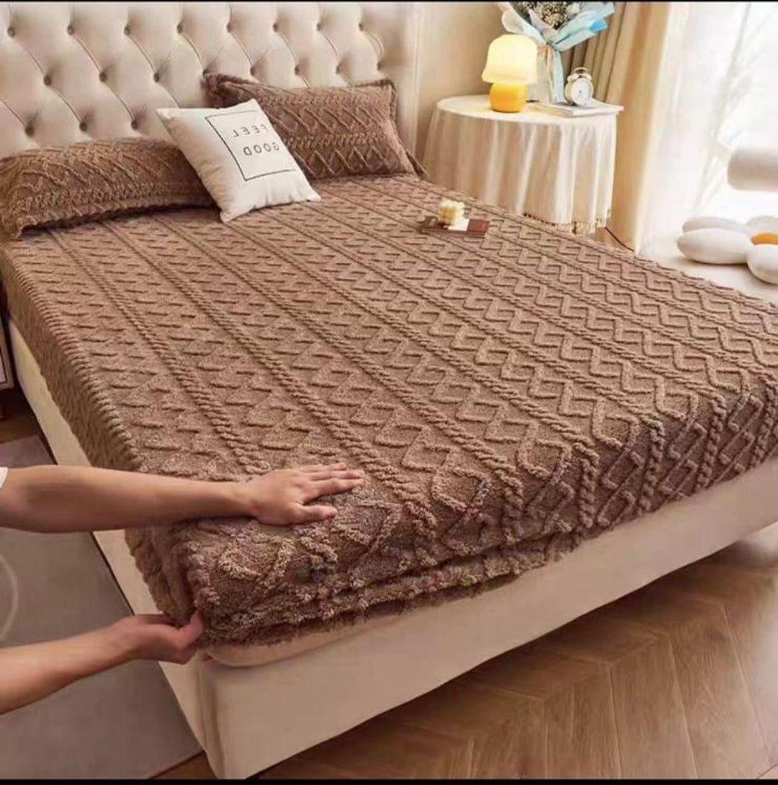 Soft chenille fitted bed cover in brown with textured geometric pattern on a beige upholstered bed