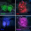 ForKumi solar powered landscape lighting in green red blue and purple illuminating garden plants at night