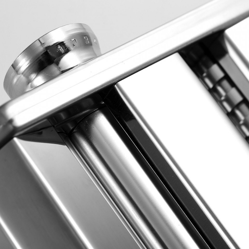 Close-up of ForKumi stainless steel pasta maker showing shiny rollers and adjustment knob