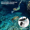 Underwater scooter for adults with removable battery shown in use by a diver swimming near a sea turtle
